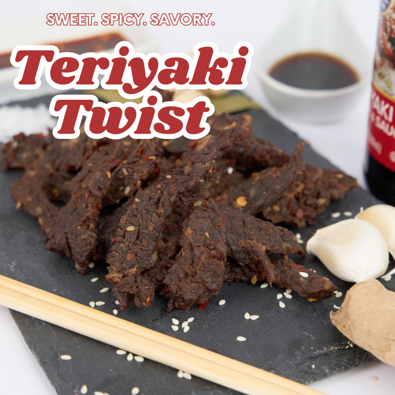 Teriyaki twist snack on a slate board with soy sauce and garlic cloves in the background.